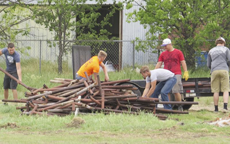 Student volunteers clear pipe from the land around Jesus Name Church which will be home to a nondenominational gathering place for youth and community events.  Courtesy / Star Kinder